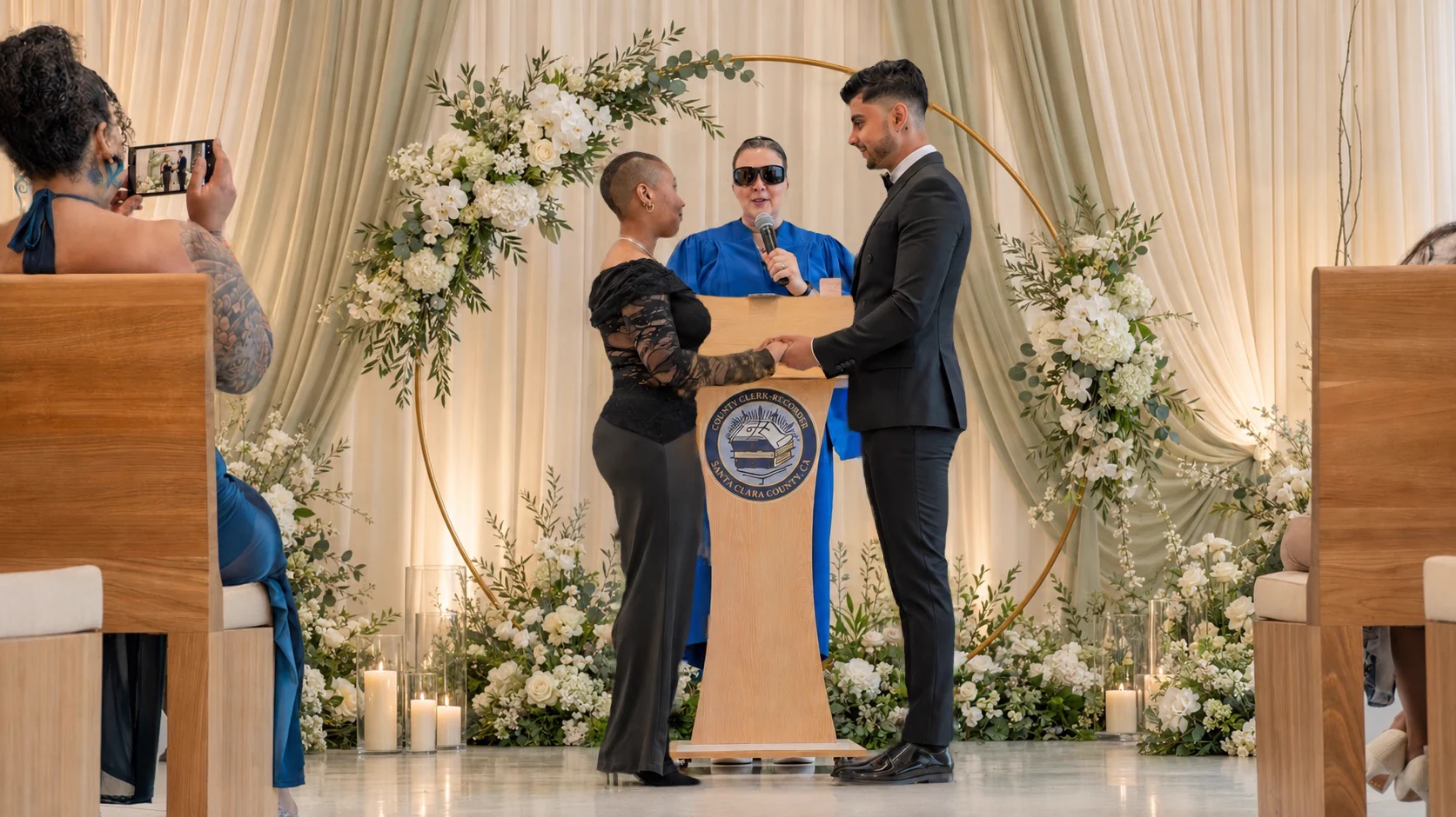Akshat and Jade standing before their officiant inside the wedding chapel